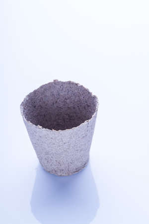 Disposable and biodegradable empty plant pot. White isolated background.の写真素材