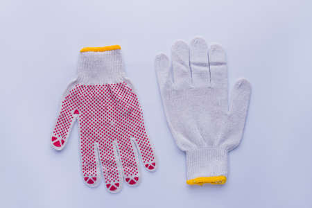 Pair of working cotton gloves. Top and down parts, flat lay, isolated on white background.の写真素材