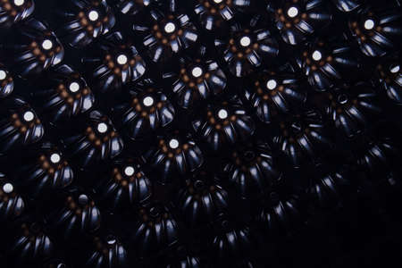 Patterned black abstract background with lighting holes. Close-up.の写真素材