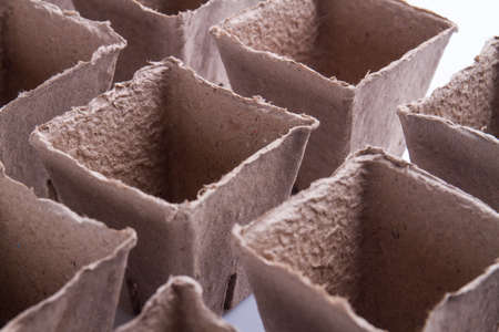 Close-up cardboard fibre square pots. Rows of empty containers.の写真素材