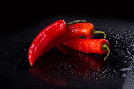 Three cayenne peppers in quaint form. Vegetable work of art.