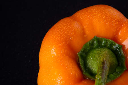 Orange pepper with little drops detailed. Sweet capsicum ready to be in salad. Food concept.