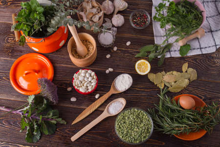 Herbs, spices and legumes on wooden table. Food cooking background.の写真素材
