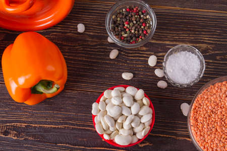 Healthy vegetables, legumes and spices on wooden table. Organic food concept.