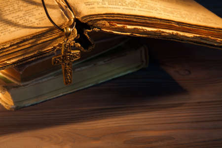 Rosary and cross on the old ancient bible. Close-up.