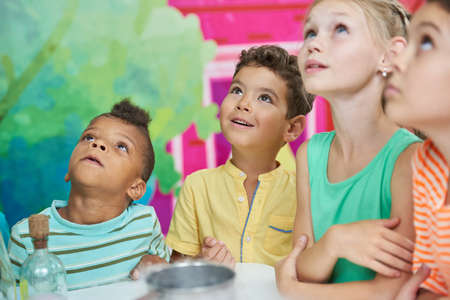 Happy children playing with animator at Birthday party. Scientific show for kids.
