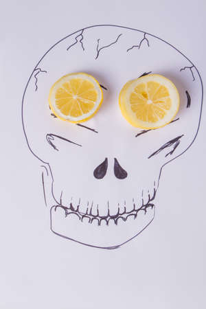 Hand drawn skull on white background. Image of skull with fresh lemon slices. Idea for Haloween Day.の写真素材