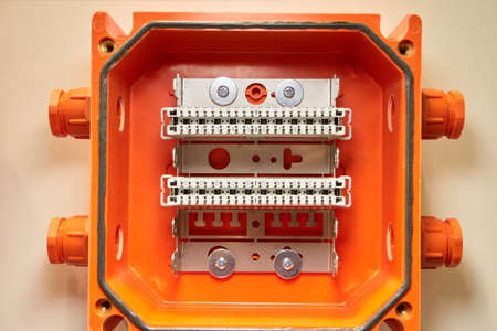 Small orange interface terminal blocks with buttons. Close up.