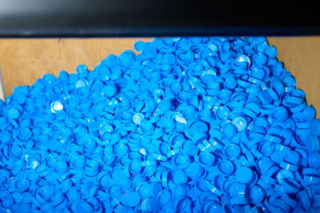 Haep of blue plastic bottle caps. Top view.