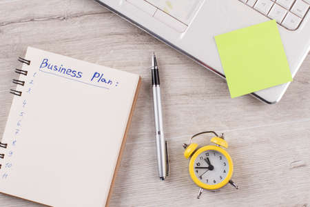 Clock, reminder and notebook . Clerk;s flatlay. Do everything, not to forget anything.の写真素材