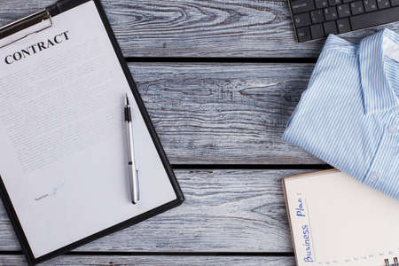 Signed contract and office items. Successful deal planned. Business concept.の写真素材