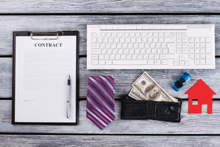 Signed contract. Mini models of car and house. Busy man flatlay. . Mens personal stuff.の写真素材