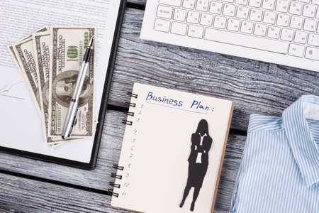 American dollars, pen and notepad . Business plan development. Office concept.