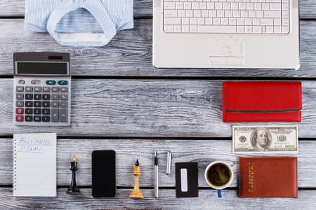 Shirt, wallet and calculator. Various office worker things on table.の写真素材