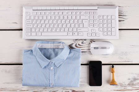 Office stuff. Shirt and PC peripherals. Cellphone and chess figure.の写真素材