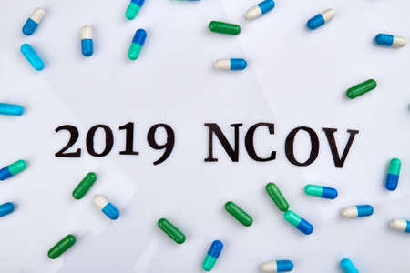 2019 ncov coronavirus concept. Colored pills isolated on white.の写真素材