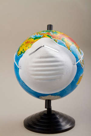 Human Epidemic Danger. Globe earth with respiratory mask isolated on white.