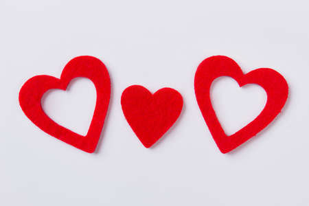 Three flat red hearts with fibre surface. Isolated on white background.の写真素材
