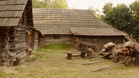 Log cabin and rural wooden trolleys. Very steep roofs of houses.の写真素材