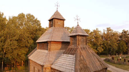 Close-up wooden church in the village. Dense forest on the background. Drone aerial photography.の写真素材