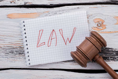 Judge hammer gavel on white wooden table. Law and punishment concept.