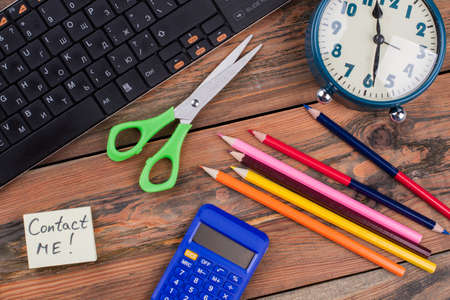 Flat lay school student accessories on brown wooden table. Top view flat lay. Scissors with pencils...