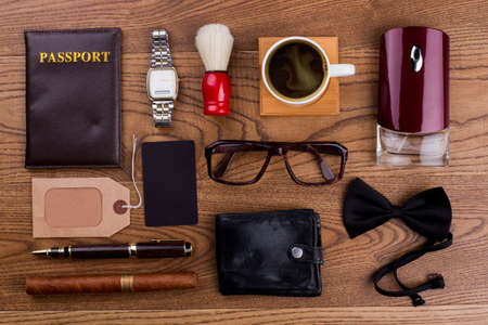 Accessories of a rich old man. Topview flat lay. Brown wooden surface.