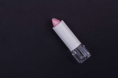 Matte pink lipstick without a cap on blackbackground. Perfect glamorous photo.の写真素材