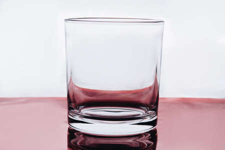 Empty small shot glass on white background. Whiskey clear glass.の写真素材