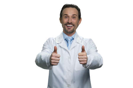 Smiling doctor with thumbs up. Good medical man isolated on white background.の写真素材