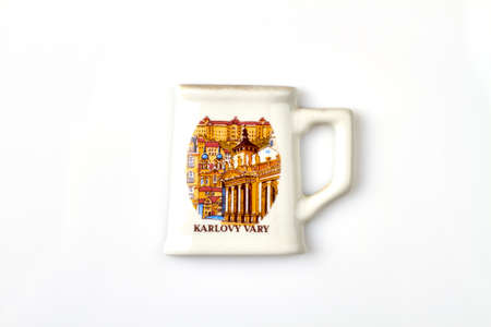White cup with Karlovy vary image. Czech republic mug souvenir. Isolated on white background.の写真素材