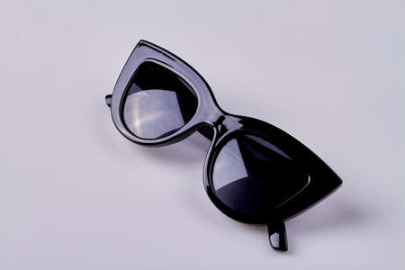 Close up black female sunglasses. Isolated on white background.