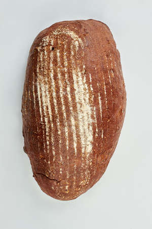 Bread on white background, top view. Loaf of healthy sourdough bread. Natural homemade food.
