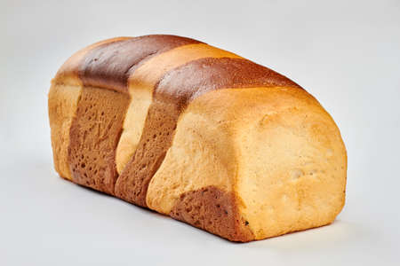 Square long loaf on white background. Homemade two color bread. Food and nutrition concept.