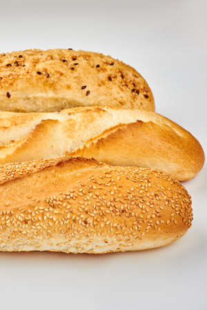 Three different baguettes on white background. Fresh delicious french bread with various seeds....
