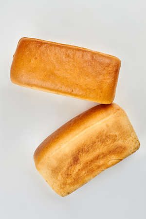 Bread on white background, top view. Two loaves of square bread.