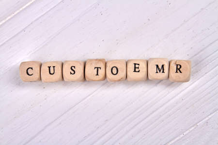 Customer word made of wooden cubes. Isoalted on white background.の写真素材