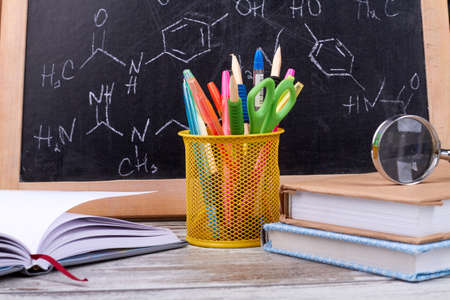 Composition of items for education. Composition of pens, books, magnifier and school board.の写真素材
