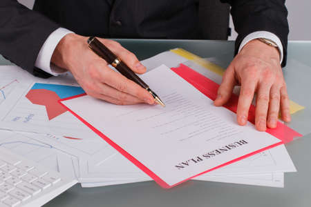 Businessman working the business plan and analysis. Close up entrepreneur working with documents....
