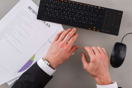 Top view of businessman hands working with keyboard and documents. Businessman working at office.の写真素材