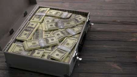 Briefcase with dollars. Dark wooden table on the background. Concept of big bribe.の写真素材