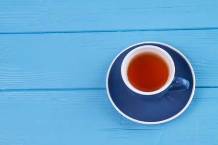 Cup of tea on blue wood. Top view wooden desk.の写真素材
