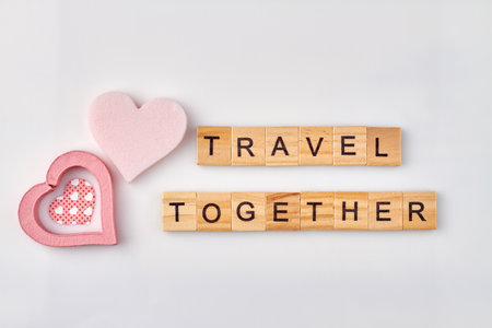 Travel together made with wooden alphabet cubes. Romantic journey concept on white background.の写真素材