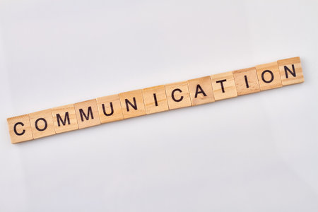 Communication is abstract concept. Wooden blocks with letters isolated on white background.の写真素材