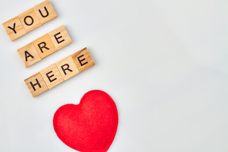 Tender words of love. Red heart represents feelings. Alphabet blocks with letters isolated on white background.の写真素材
