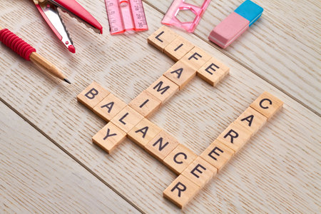 Career and family life balance. Scissors with ruler and pencil on the wooden desk.の写真素材