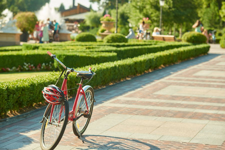 Bicycles in the park. Single bike and helmet with no people.の写真素材