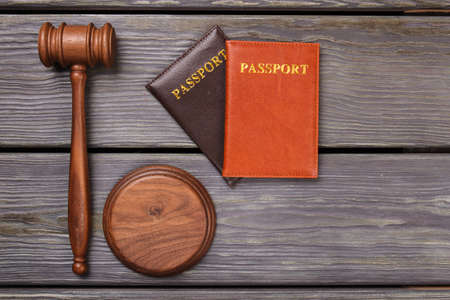 Passports and gavel on wood. Top view flat lay deportation concept.の写真素材