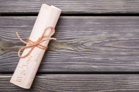 Scroll letter on wooden desk. Close-up flat lay.の写真素材