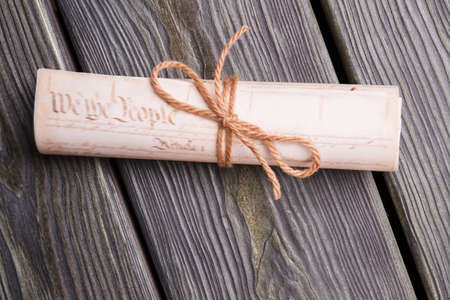 Old scroll tied with rope. Close-up rolled papers with bow.